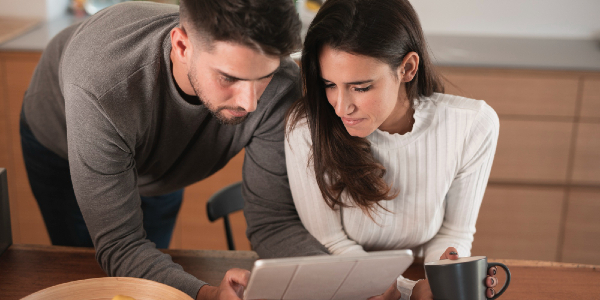 Couple reviewing financial documents and credit scores together